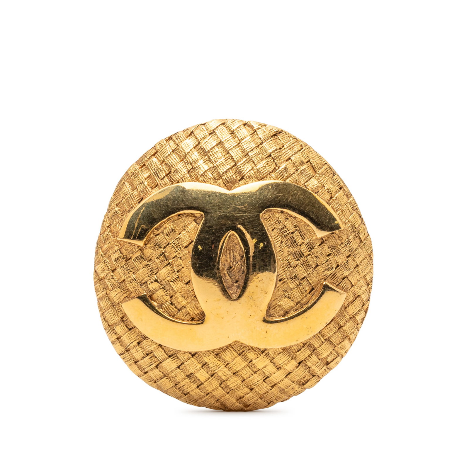 Chanel Woven Metal Brooch with Gold Tone Finish and CC Motif: Chanel Woven Metal Brooch with Gold Tone Finish and CC Motif This Chanel brooch features a round design with the iconic CC logo, crafted from gold tone metal with a woven motif. It is secured with a b