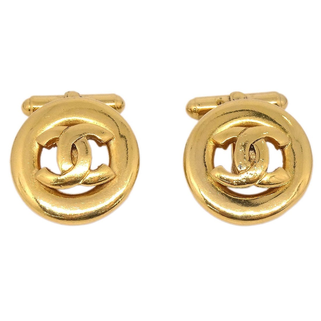 Chanel Gold Tone Button Logo Earrings: Chanel Gold Tone Button Logo Earrings These Chanel earrings feature a classic button shape in a gold-tone finish, showcasing the iconic logo theme. Designed for a sophisticated look, they combine eleg