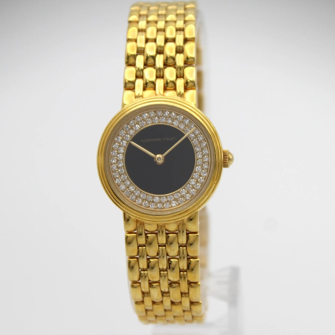 Vintage 24mm Audemars Piguet 18K Gold Wristwatch With Onyx Dial and Diamond Bezel: Vintage 24mm Audemars Piguet 18K Gold Wristwatch With Onyx Dial and Diamond Bezel This Audemars Piguet vintage wristwatch features a 24mm round case crafted from 18K yellow gold. The elegant black ony