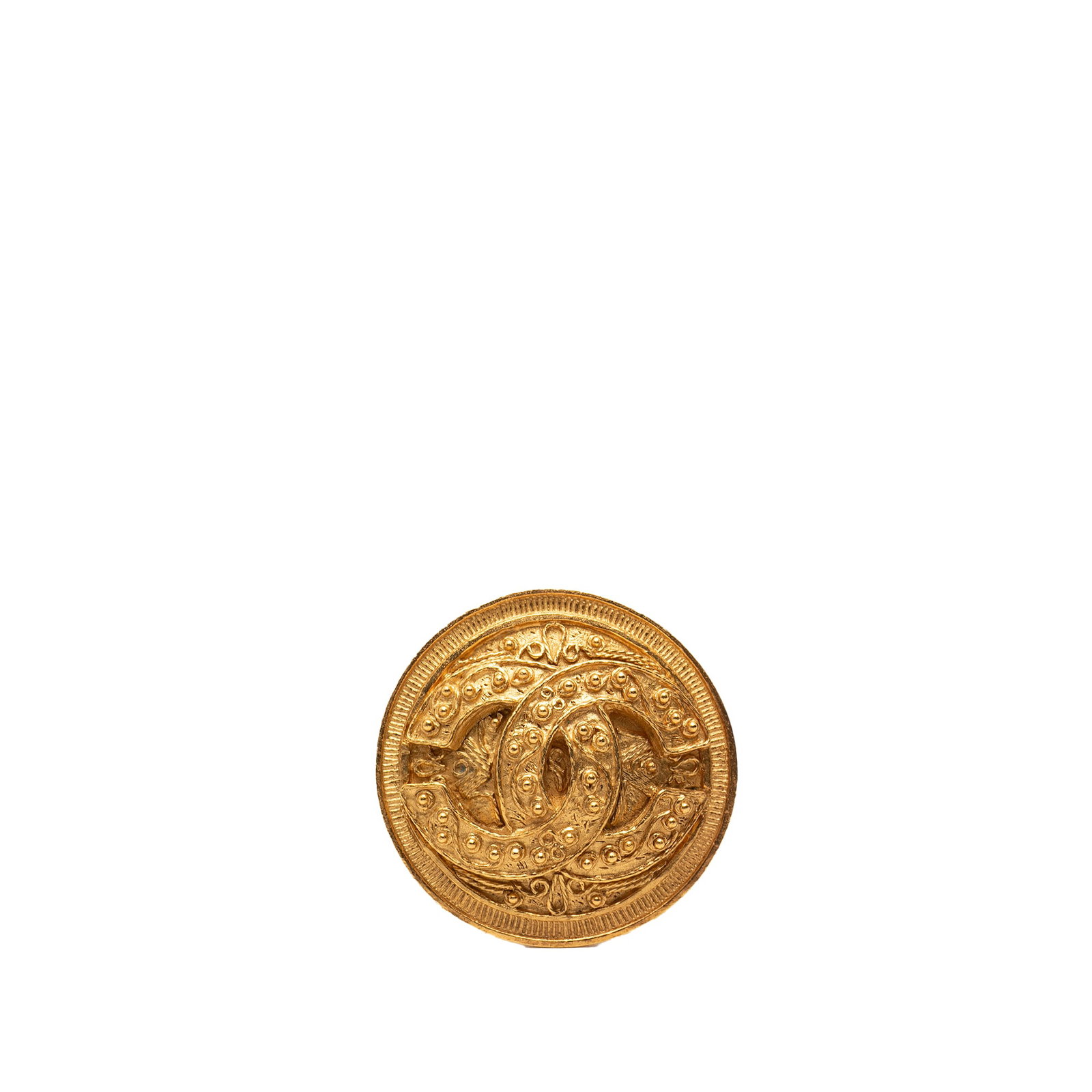 Chanel CC Medallion Brooch in Gold Tone Metal: Chanel CC Medallion Brooch in Gold Tone Metal This Chanel brooch features a round medallion design crafted from gold-tone metal with a back pin closure. The piece is categorized as costume jewelry and