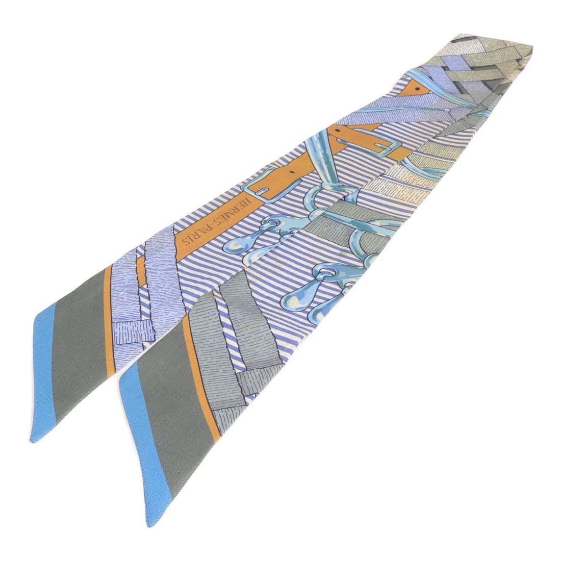 Hermes Twilly Silk Scarf in Blue and Gray for Women: Hermes Twilly Silk Scarf in Blue and Gray for Women This Hermes Twilly scarf is crafted from silk in a blue and gray color palette. Designed for women, it features a regular size and showcases the bra