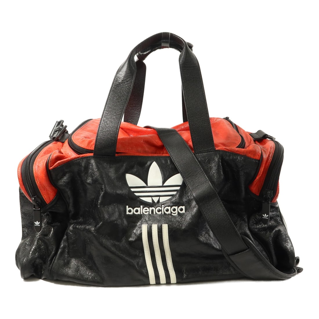 Balenciaga Adidas 2way Shoulder Bag Calfskin Black Red: Balenciaga Adidas 2way Shoulder Bag Calfskin Black Red This vintage Balenciaga x Adidas weekend bag is crafted from high-quality calfskin leather in black with red accents. Designed as a 2-way shoulde