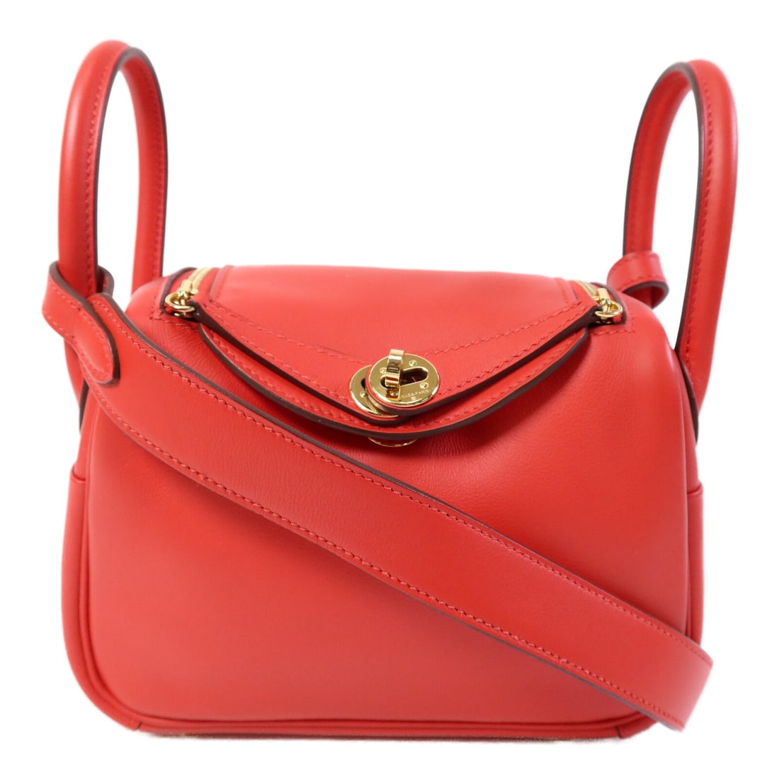 Mini Lindy Red Swift Leather Shoulder Bag with Gold Hardware by Hermes: Mini Lindy Red Swift Leather Shoulder Bag with Gold Hardware by Hermes This Hermes Mini Lindy is a versatile 2-way shoulder bag crafted from premium Swift leather in a rich red hue. The bag features g