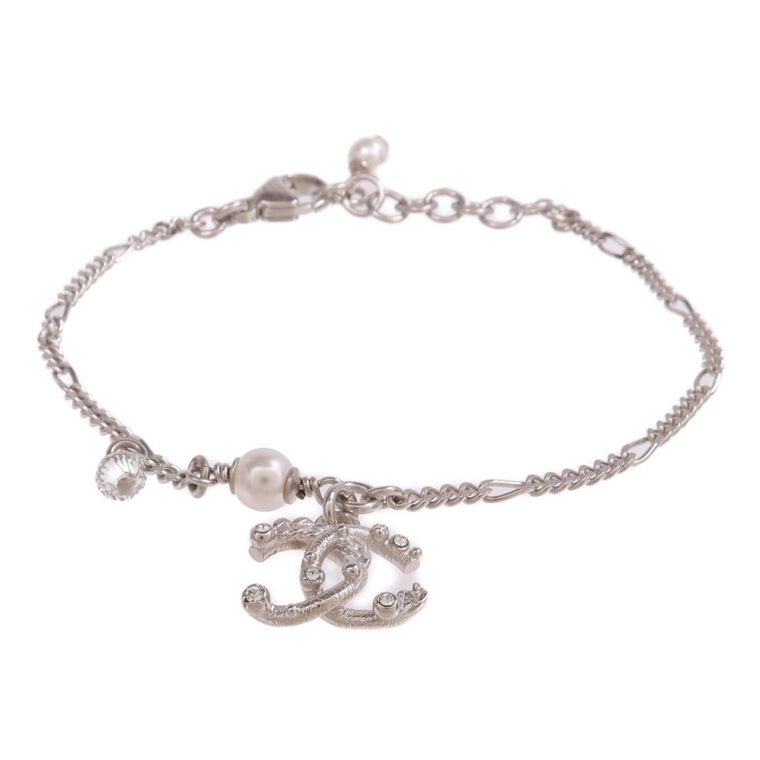 Silver Tone CC Logo Bracelet by CHANEL: Silver Tone CC Logo Bracelet by CHANEL This CHANEL CC bracelet features a sleek silver-tone design, crafted from metal. The bracelet does not include any stones and is designed in a regular size. Made