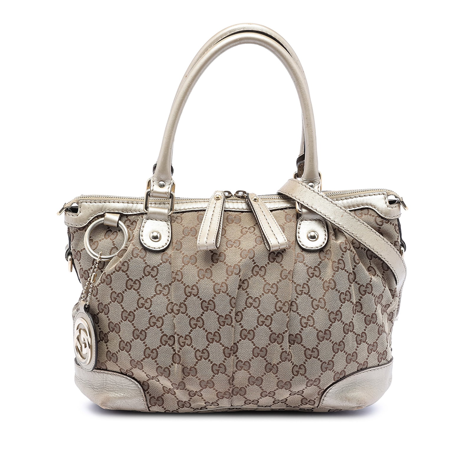 Gucci Sukey Beige Canvas Satchel with Leather Trim and Shoulder Strap: Gucci Sukey Beige Canvas Satchel with Leather Trim and Shoulder Strap The Gucci GG Canvas Sukey Satchel features a beige canvas body with leather trim, rolled leather handles, and a detachable, adjust
