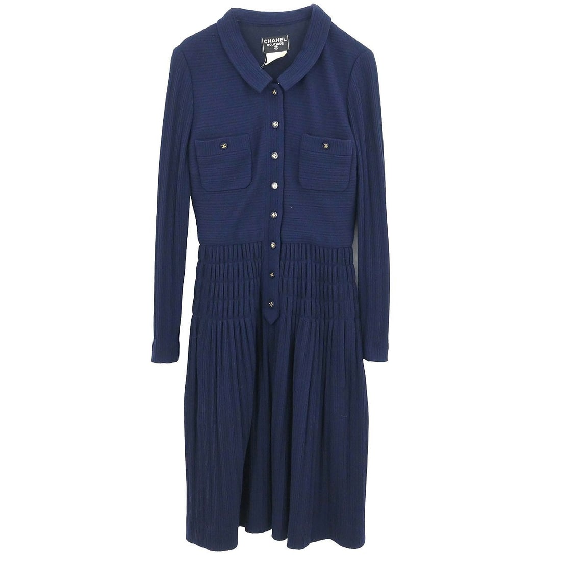 CHANEL Navy Wool Sweater Dress FR 38: CHANEL Navy Wool Sweater Dress FR 38 This vintage Chanel sweater dress is crafted from 100% wool in a classic navy color. Featuring long sleeves, a button closure, and signature logo accents, it offer