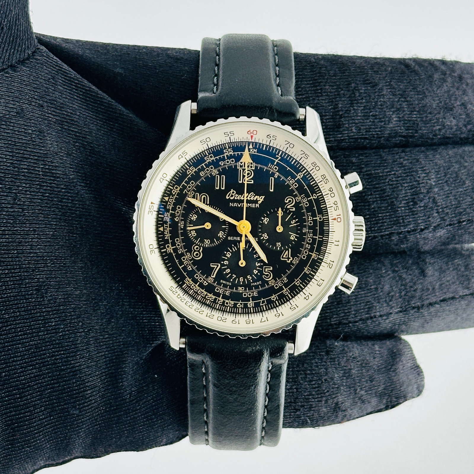 Navitimer A11022.1 Watch with Black and Yellow Arabic Dial on Leather Strap: Navitimer A11022.1 Watch with Black and Yellow Arabic Dial on Leather Strap This Breitling Navitimer watch features a black dial with yellow Arabic markers and a rotating bezel. It is paired with a le