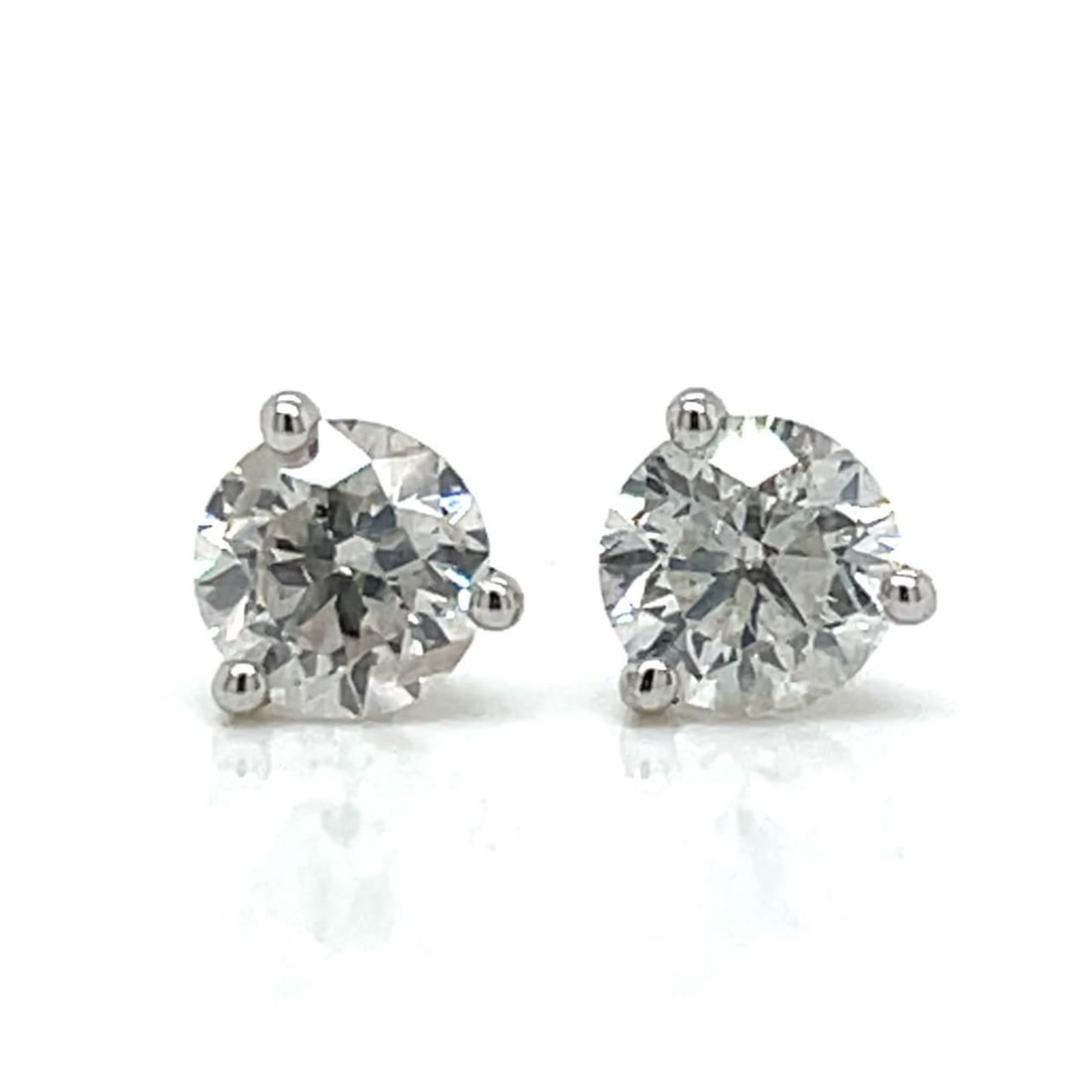 14K White Gold Diamond Stud Earrings 1.25 Ct H-I SI2-I1: 14K White Gold Diamond Stud Earrings 1.25 Ct H-I SI2-I1 These stunning 14K white gold diamond stud earrings feature two beautifully matched diamonds weighing approximately 1.25 carats in total. The di