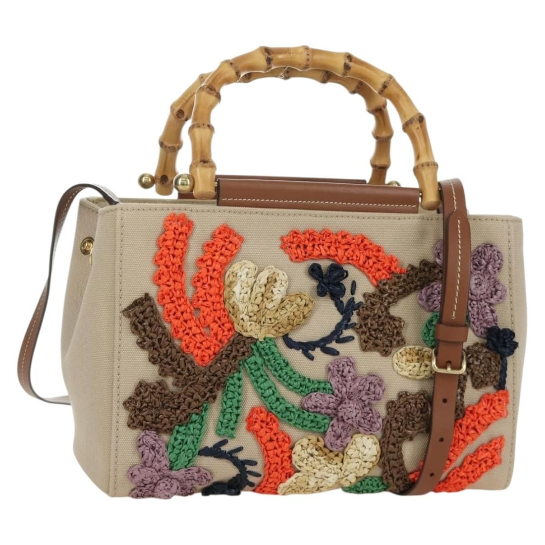 Beige Canvas Bamboo Handle Shoulder Bag by Miu Miu with Gold Accents: Beige Canvas Bamboo Handle Shoulder Bag by Miu Miu with Gold Accents This Miu Miu bamboo handle handbag features a beige and gold canvas exterior and offers versatile 2-way carrying options with both 