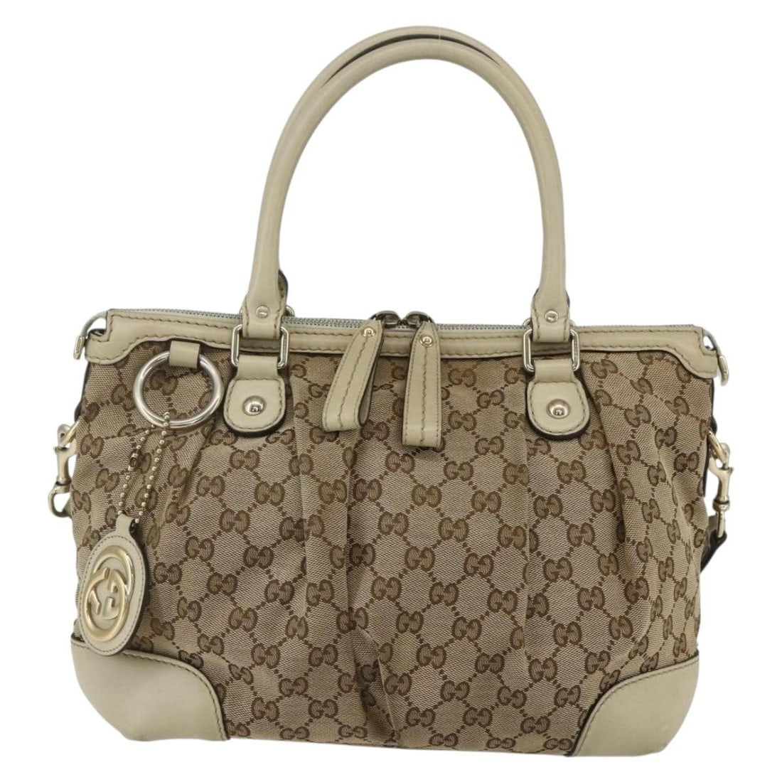 Beige Gucci Sukey Canvas Satchel with Top Handle 27cm: Beige Gucci Sukey Canvas Satchel with Top Handle 27cm The Gucci Sukey Top Handle Satchel is a female handbag made from beige canvas with GG coated detailing. It features a top handle and a shoulder st