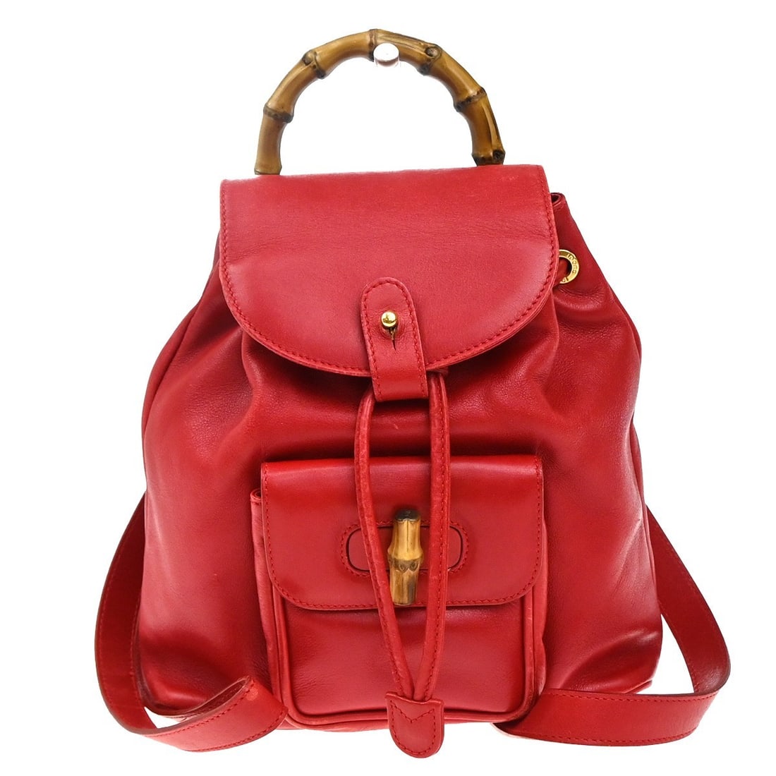 Red Leather Gucci Vintage Bamboo Shoulder Backpack 21cm by 26cm: Red Leather Gucci Vintage Bamboo Shoulder Backpack 21cm by 26cm This Gucci vintage bamboo backpack for women is crafted in red leather featuring the iconic bamboo handle. The backpack shows signs of w