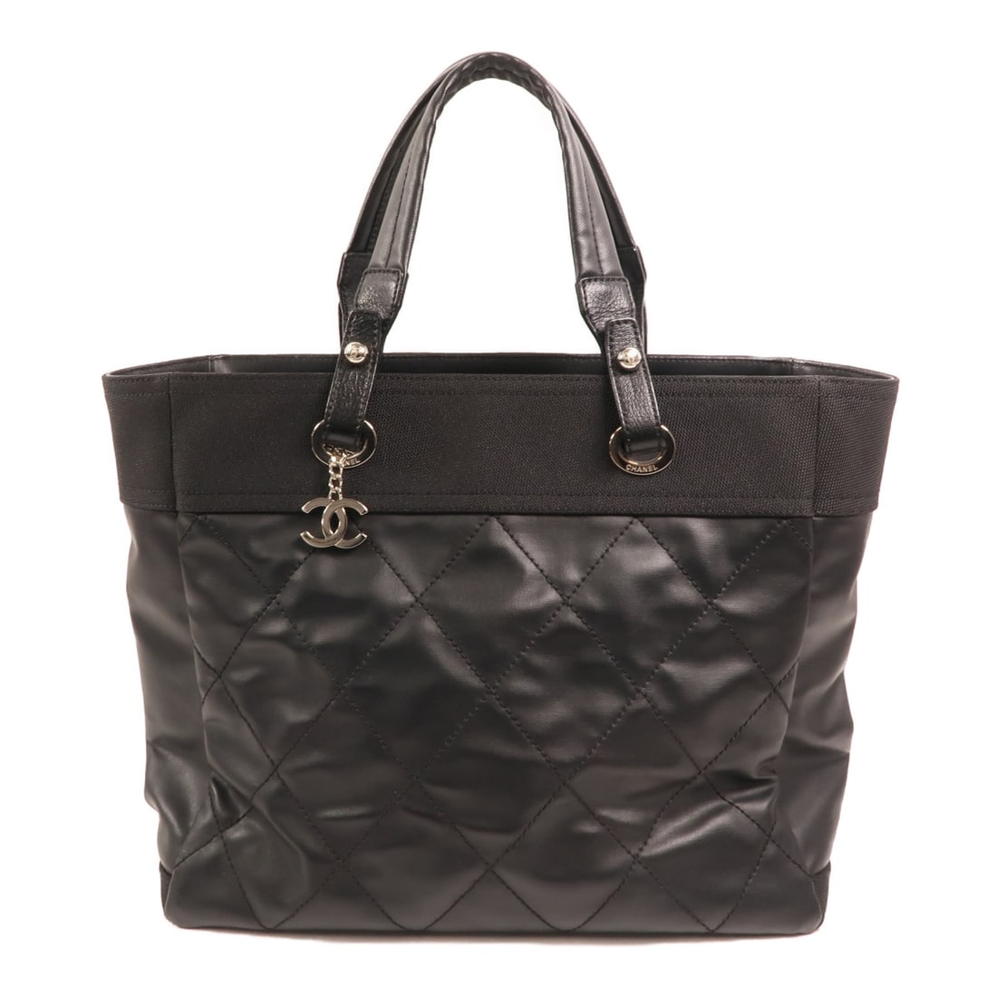 Chanel Black Canvas Nylon Tote Bag with Silver CC Hardware: Chanel Black Canvas Nylon Tote Bag with Silver CC Hardware This CHANEL tote bag features a black canvas exterior with nylon elements, designed for a stylish and practical look. The bag offers ample sp