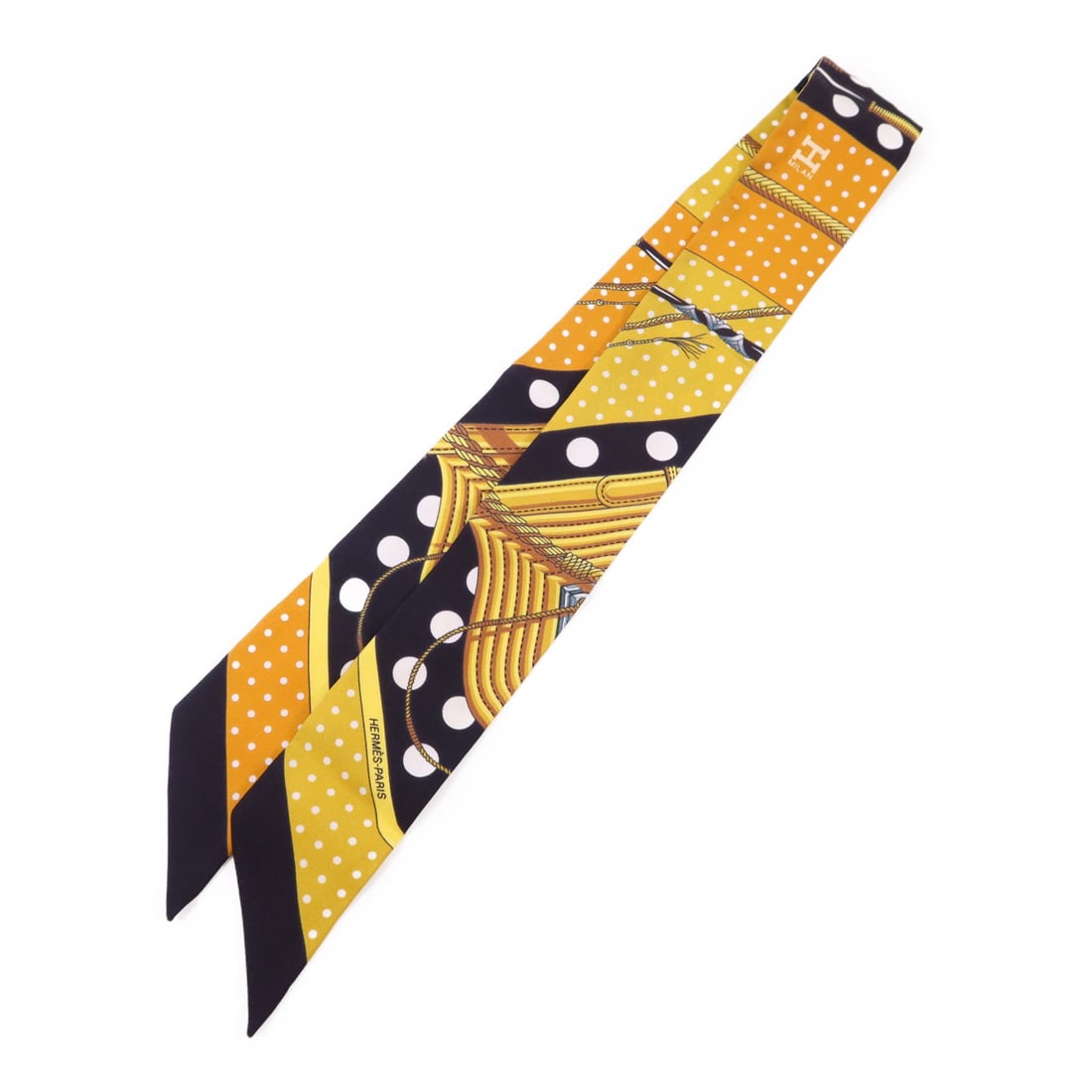 Silk Twilly Black and Yellow Scarf by Hermes France: Silk Twilly Black and Yellow Scarf by Hermes France This Hermes Twilly scarf is crafted from silk and features a black and yellow color scheme. Made in France, this scarf is in very good condition and
