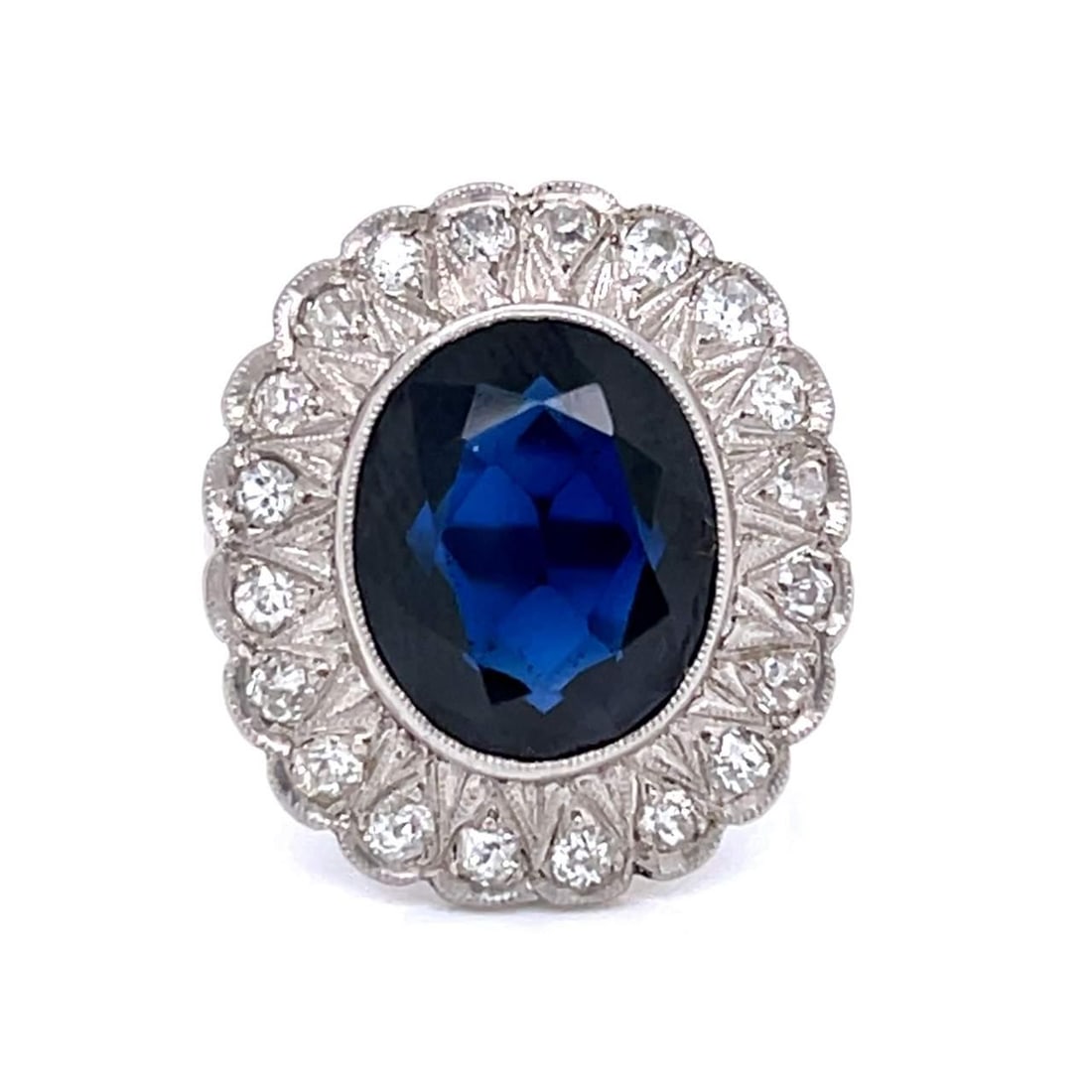 Art Deco Platinum Ring with 5.00 Ct Synthetic Sapphire and 20 Diamonds: Art Deco Platinum Ring with 5.00 Ct Synthetic Sapphire and 20 Diamonds This exquisite Art Deco ring features a stunning synthetic sapphire weighing approximately 5.00 Ct, elegantly set in luxurious pl