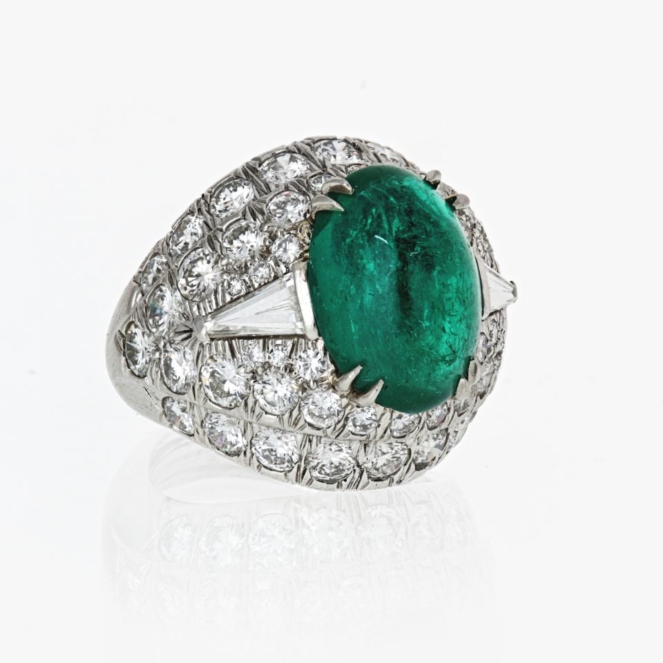 David Webb Platinum Bombe Ring with 6.65ct Emerald and Diamonds: David Webb Platinum Bombe Ring with 6.65ct Emerald and Diamonds This exquisite bombe ring by David Webb showcases a stunning oval cabochon emerald, weighing 6.65 carats, surrounded by a dazzling array