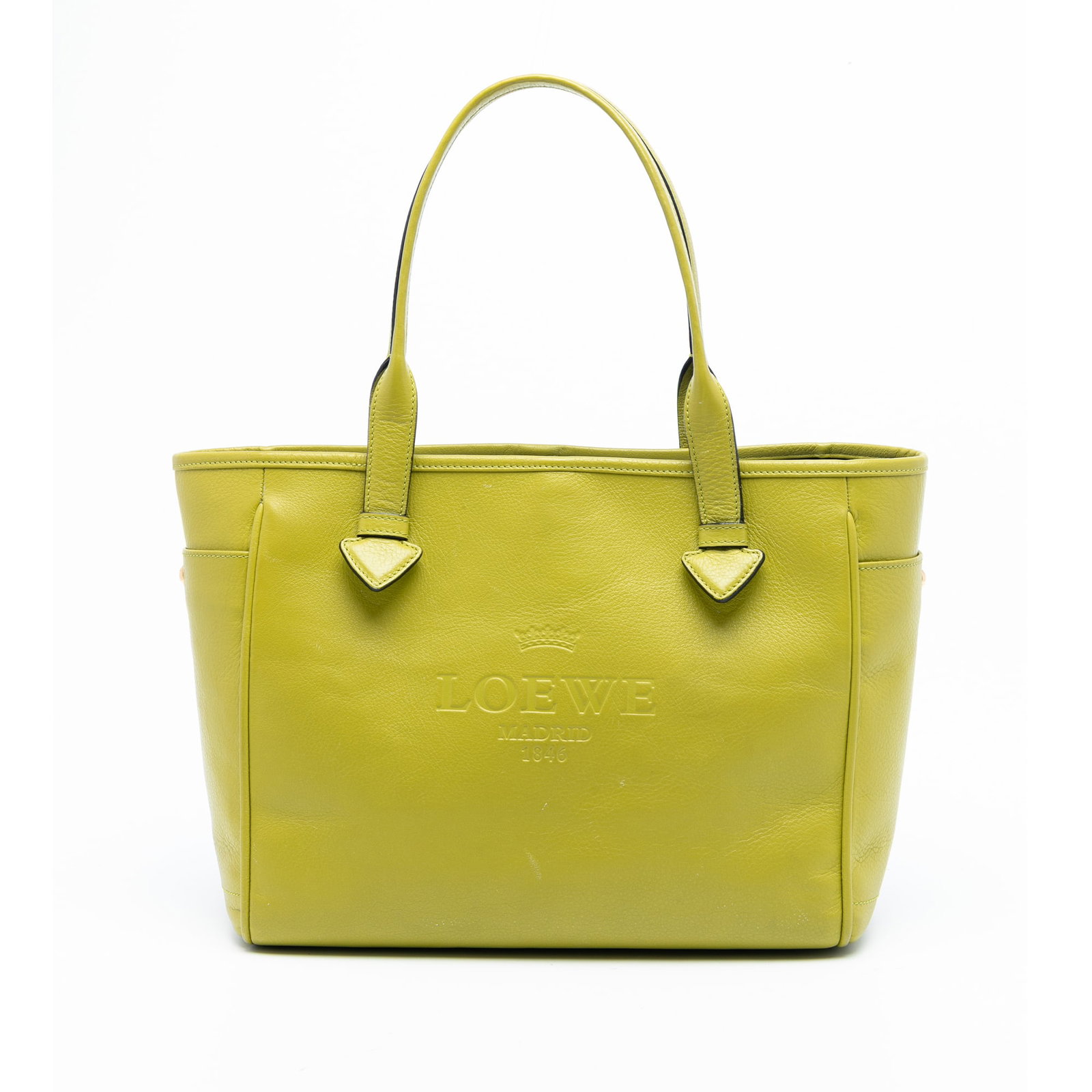 Green Leather Tote Bag by LOEWE Heritage Collection: Green Leather Tote Bag by LOEWE Heritage Collection This LOEWE Leather Heritage Tote features a green leather body with rolled leather handles and an open top secured by a hook lock closure. It includ