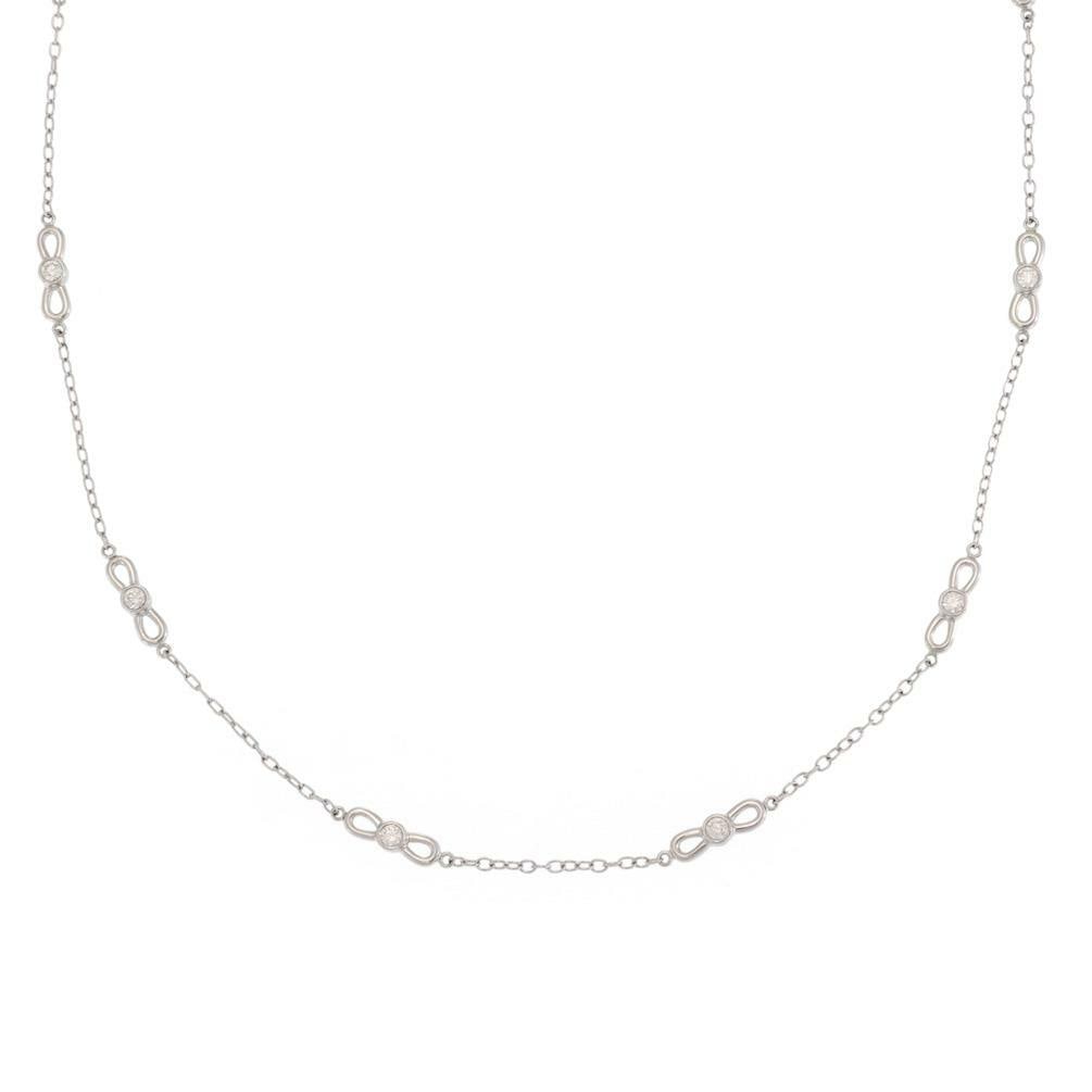Tiffany & Co 18k White Gold Diamond Bow Motif Necklace: Tiffany & Co 18k White Gold Diamond Bow Motif Necklace This exquisite necklace from Tiffany & Co. is meticulously crafted from 18k white gold, showcasing a polished finish. The design features an oval