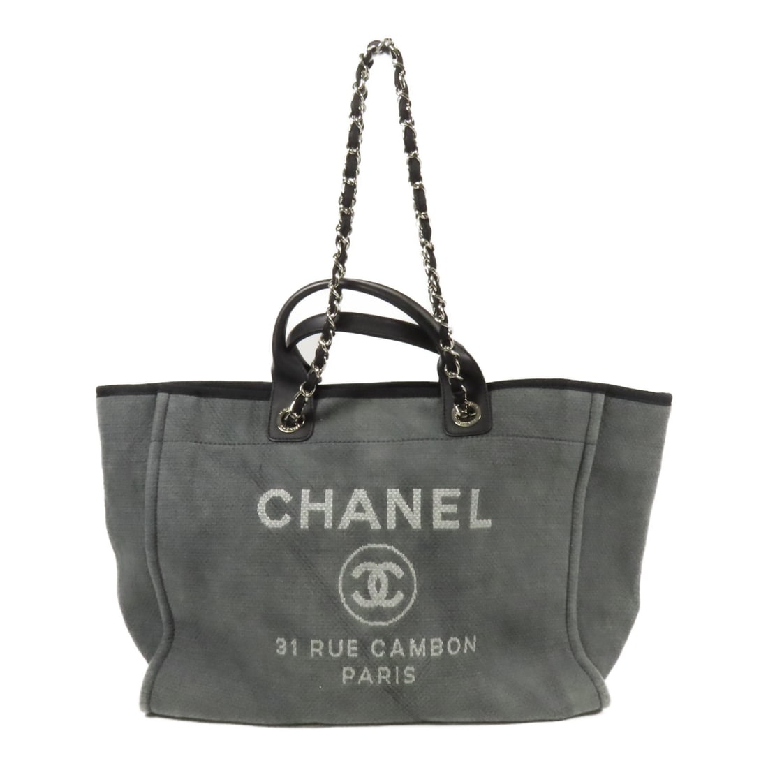 Deauville Canvas Tote by CHANEL in Grey with Silver Hardware: Deauville Canvas Tote by CHANEL in Grey with Silver Hardware This CHANEL Deauville Tote is a versatile 2-way shoulder bag crafted from gray canvas. Made in France, it offers both style and function, f