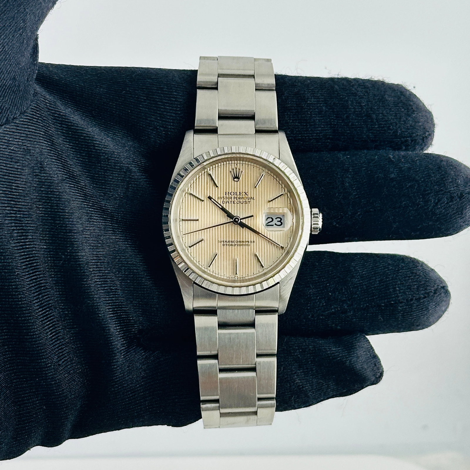 Ivory Tapestry Dial Datejust Watch Ref 16220 with Oyster Bracelet: Ivory Tapestry Dial Datejust Watch Ref 16220 with Oyster Bracelet This Rolex Datejust features an ivory tapestry dial and is presented on an Oyster bracelet. The watch includes an engine-turned bezel 