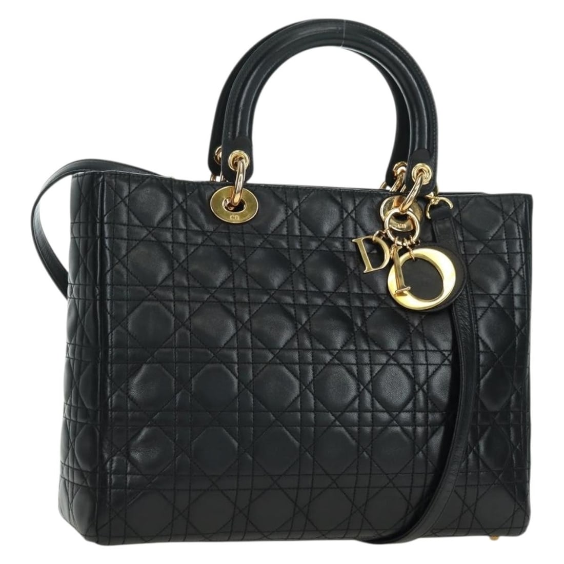 Lady Dior lambskin black gold handbag with strap and charm: Lady Dior lambskin black gold handbag with strap and charm This Christian Dior Lady Dior Canage 2-way handbag is crafted from luxurious black lambskin with gold-tone accents. Designed for versatility,