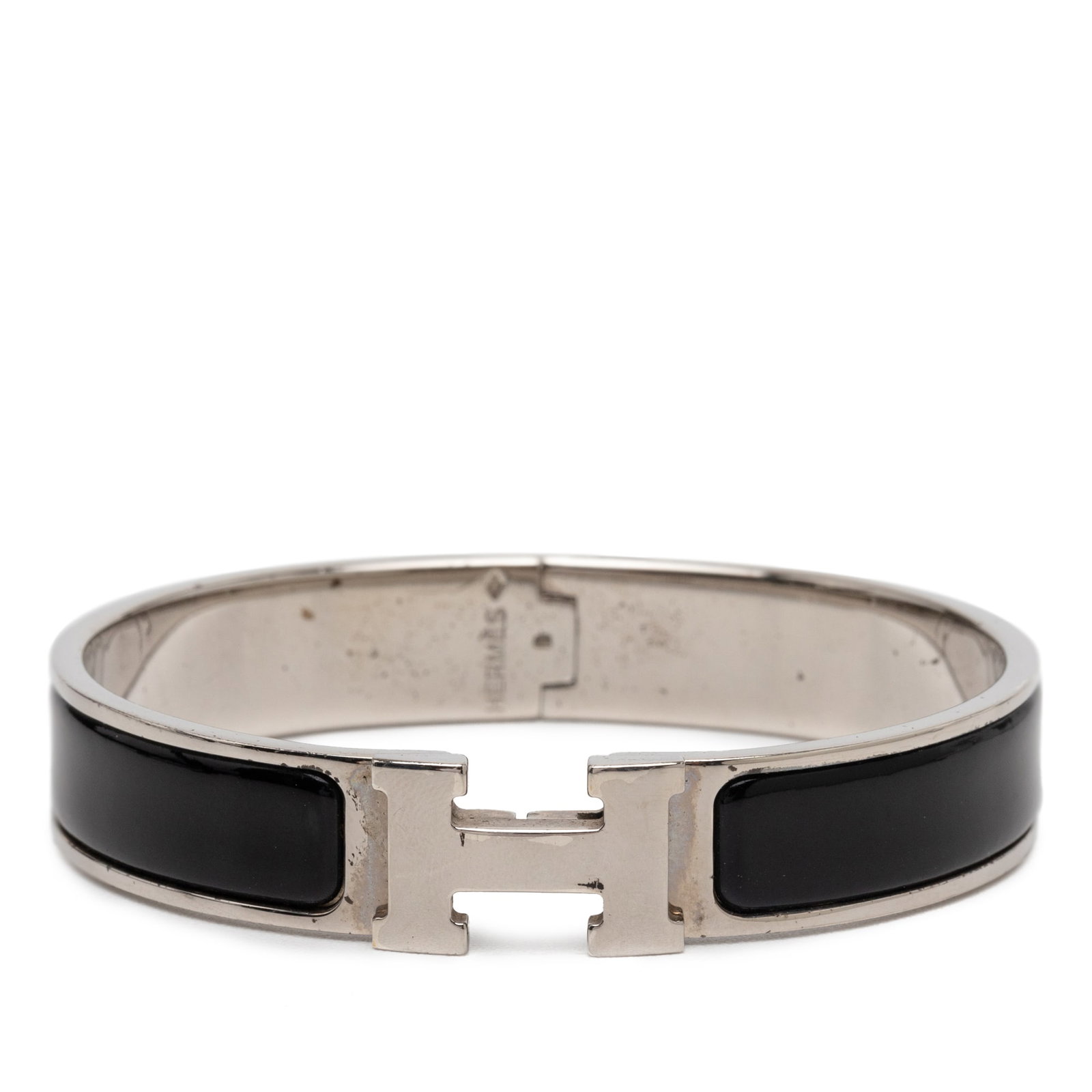 Hermes Clic H PM Black Enamel Narrow Palladium Plated Bracelet: Hermes Clic H PM Black Enamel Narrow Palladium Plated Bracelet This Hermes Narrow Enamel Clic H Bracelet PM features a sleek enamel body with palladium plated metal and is secured with an H toggle cla