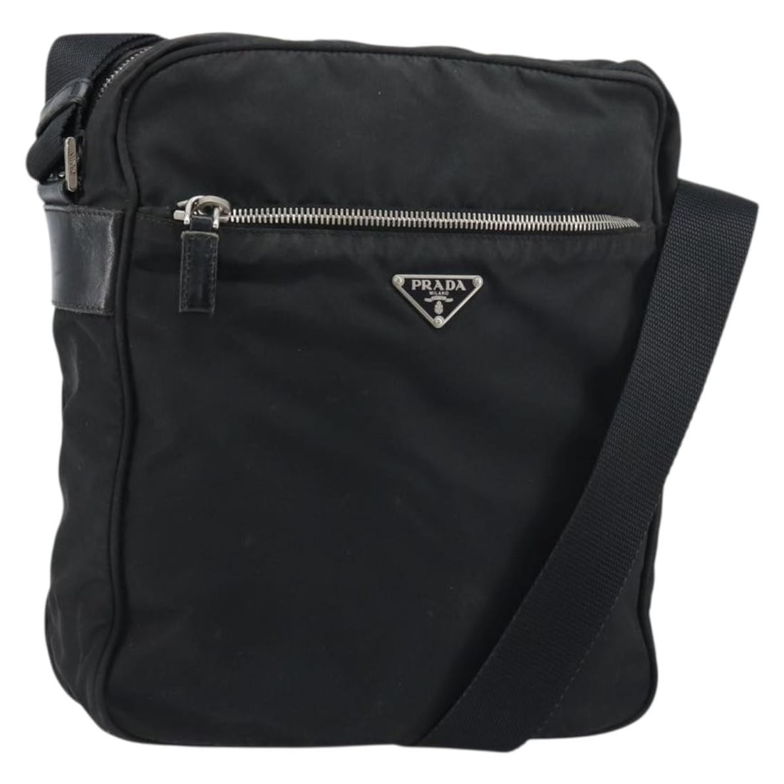 Prada Tessuto Nylon Messenger Bag with Saffiano Leather Accents: Prada Tessuto Nylon Messenger Bag with Saffiano Leather Accents The Prada Front Pocket Zip Messenger Bag is crafted from durable black nylon with Saffiano leather accents. Designed for unisex use, thi