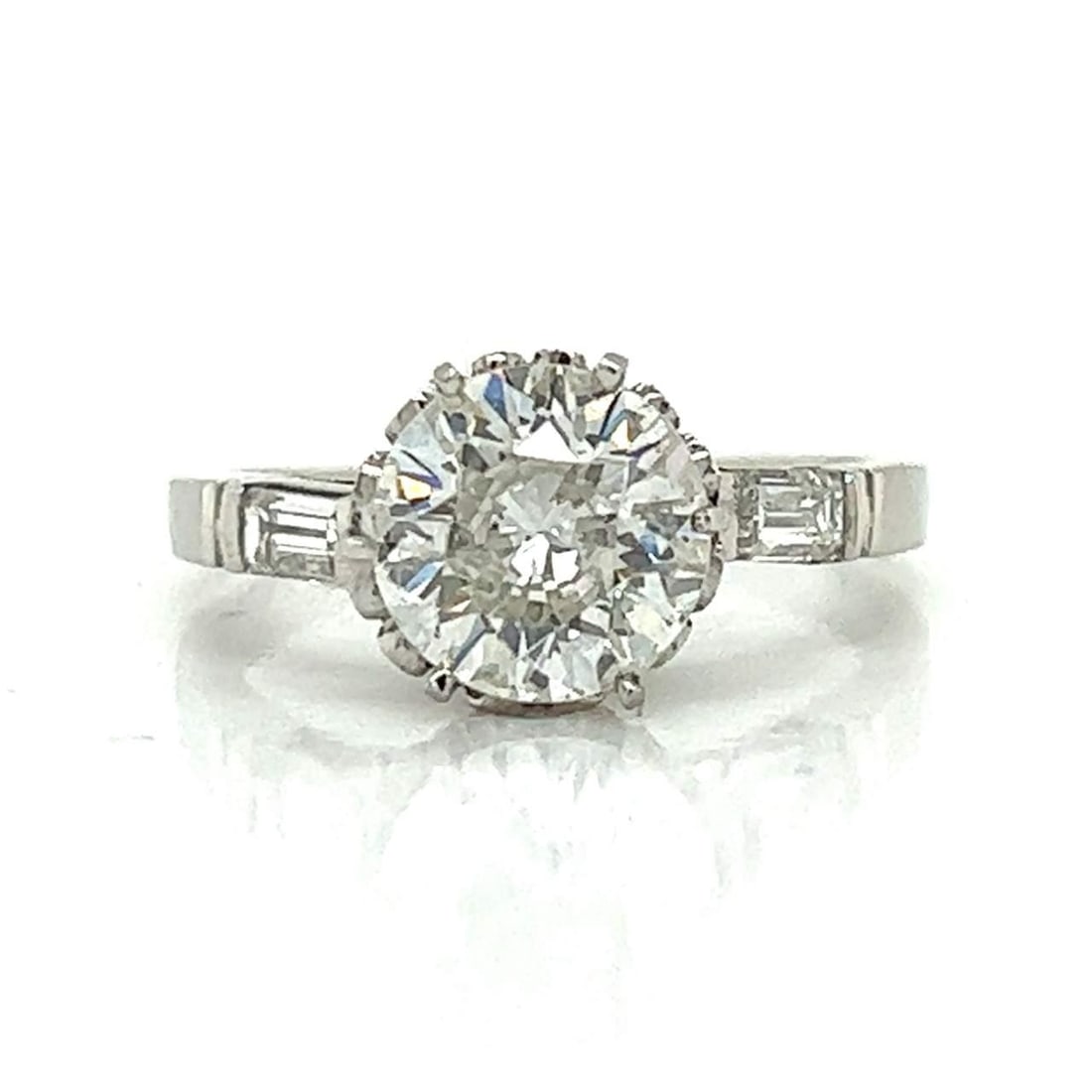 Art Deco Platinum Ring with 1.89 Ct Diamond and 2 Accent Diamonds: Art Deco Platinum Ring with 1.89 Ct Diamond and 2 Accent Diamonds This exquisite Art Deco ring is crafted in platinum and showcases a stunning 1.89 Ct. diamond, boasting a G color and SI2 clarity. The