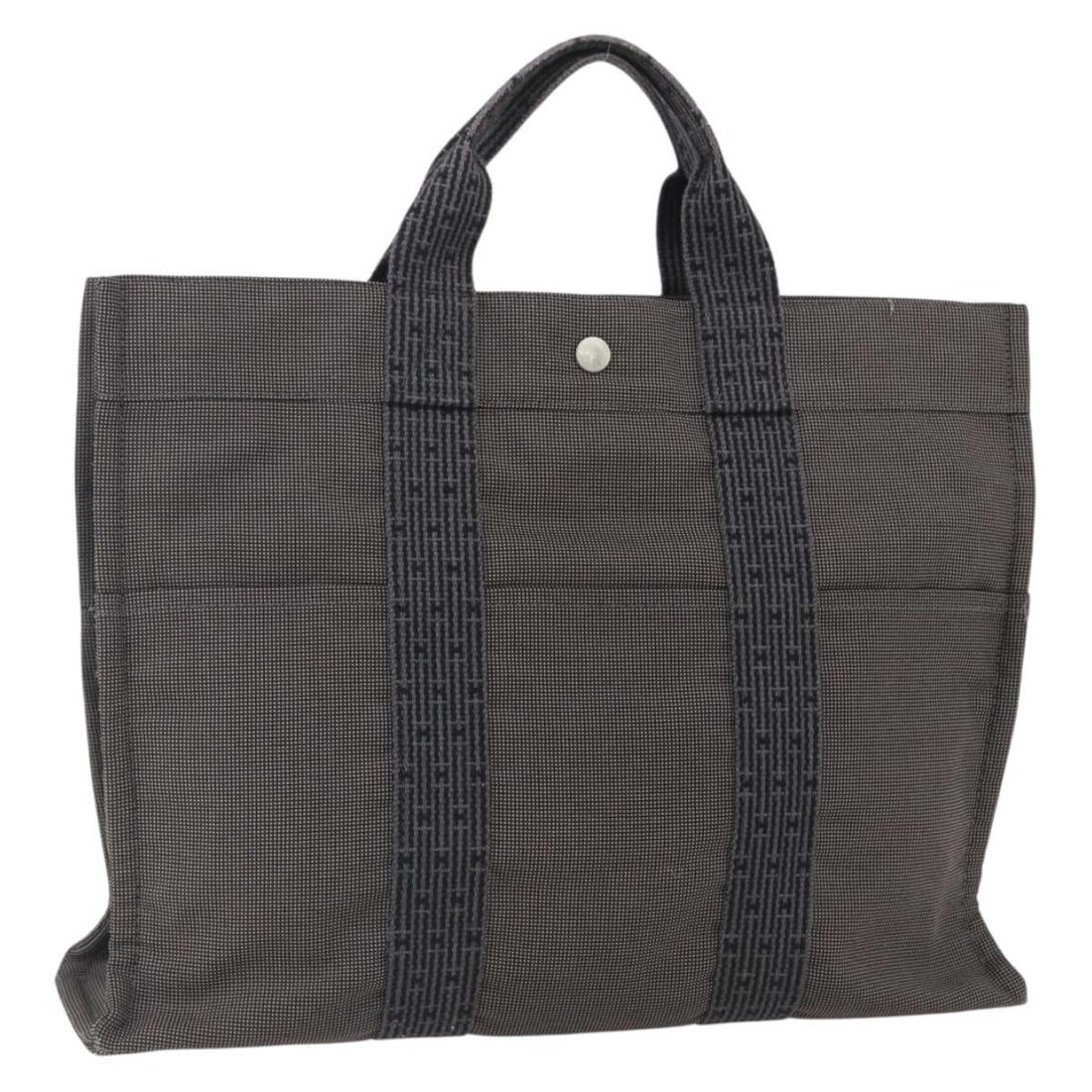 Canvas Her Line Tote MM Handbag by Hermes Gray Silver: Canvas Her Line Tote MM Handbag by Hermes Gray Silver This Hermes Her Line Tote MM handbag features gray and silver canvas exterior with a structured silhouette. Crafted in France, the bag includes me