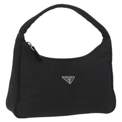 Prada Black Nylon Top Handle Pouch Silver Tone: Prada Black Nylon Top Handle Pouch Silver Tone This Prada hand pouch is crafted from black nylon with silver-tone accents. The bag features a top handle and a compact, structured silhouette. Made in I