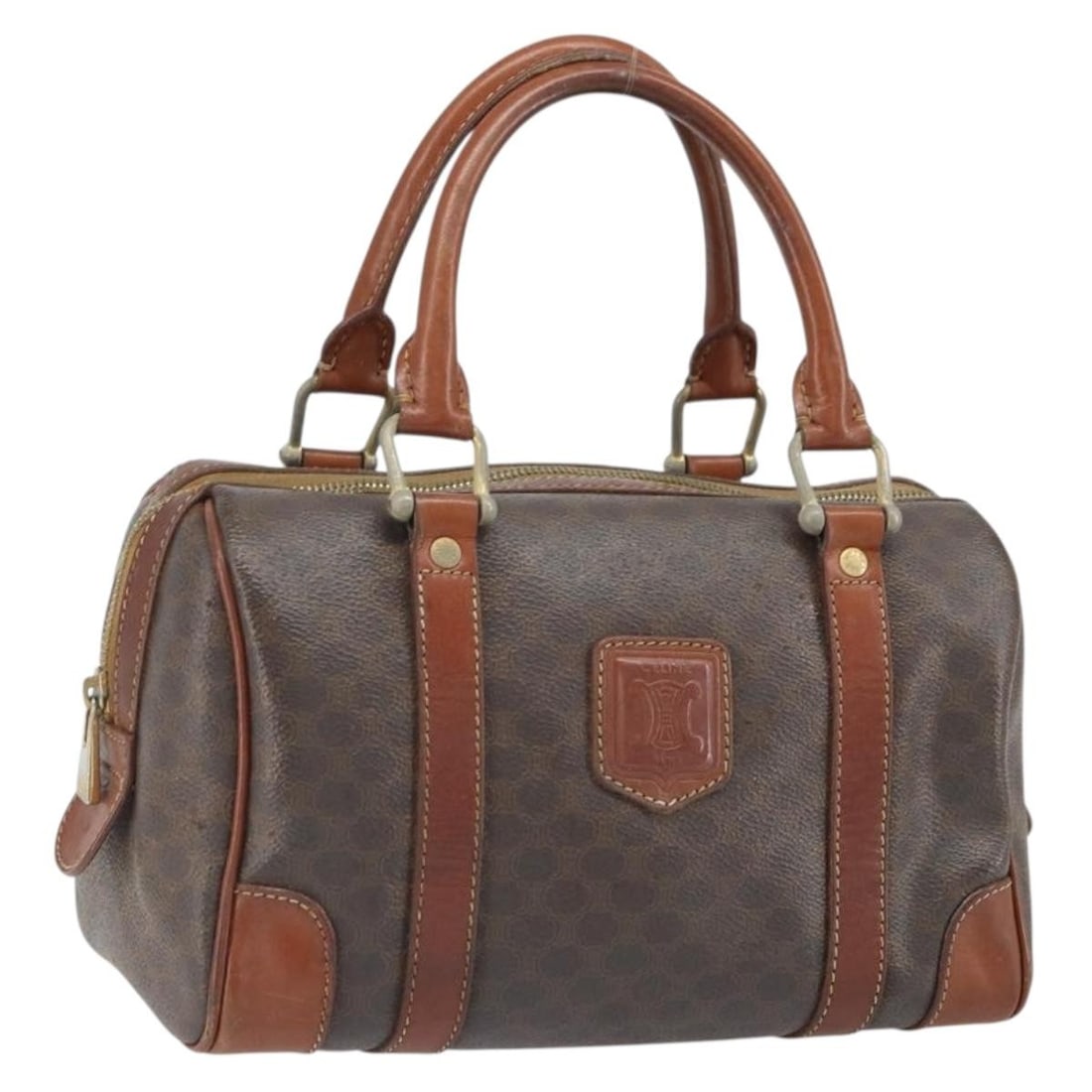 Brown PVC Macadam Canvas Handbag by CELINE with Gold Tone Details: Brown PVC Macadam Canvas Handbag by CELINE with Gold Tone Details This CELINE Macadam canvas hand bag features a classic brown and gold color scheme, crafted from durable PVC leather and Macadam canva