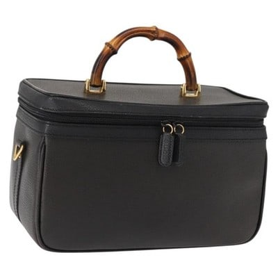 GUCCI Bamboo leather vanity handbag navy gold Italy 013 122 2491: GUCCI Bamboo leather vanity handbag navy gold Italy 013 122 2491 This Gucci Bamboo Vanity Hand Bag is crafted from navy leather with gold-tone accents, featuring the iconic bamboo handle. The bag offe