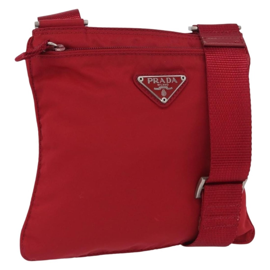 Red Nylon Shoulder Purse by Prada with Silver Accents: Red Nylon Shoulder Purse by Prada with Silver Accents This PRADA shoulder bag is crafted from red nylon with silver-tone accents and is designed for women. Made in Italy, the bag features an adjustabl