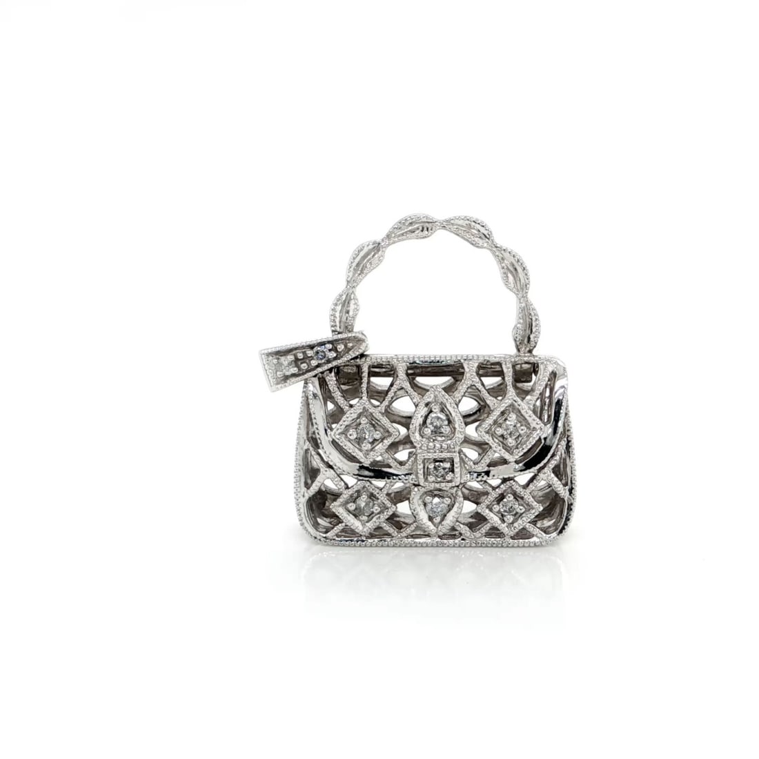 14k White Gold Diamond Handbag Charm Pendant: 14k White Gold Diamond Handbag Charm Pendant This 14k white gold purse charm pendant features an open handbag design with intricate filigree and delicate milgrain detailing. The pendant is accented wi