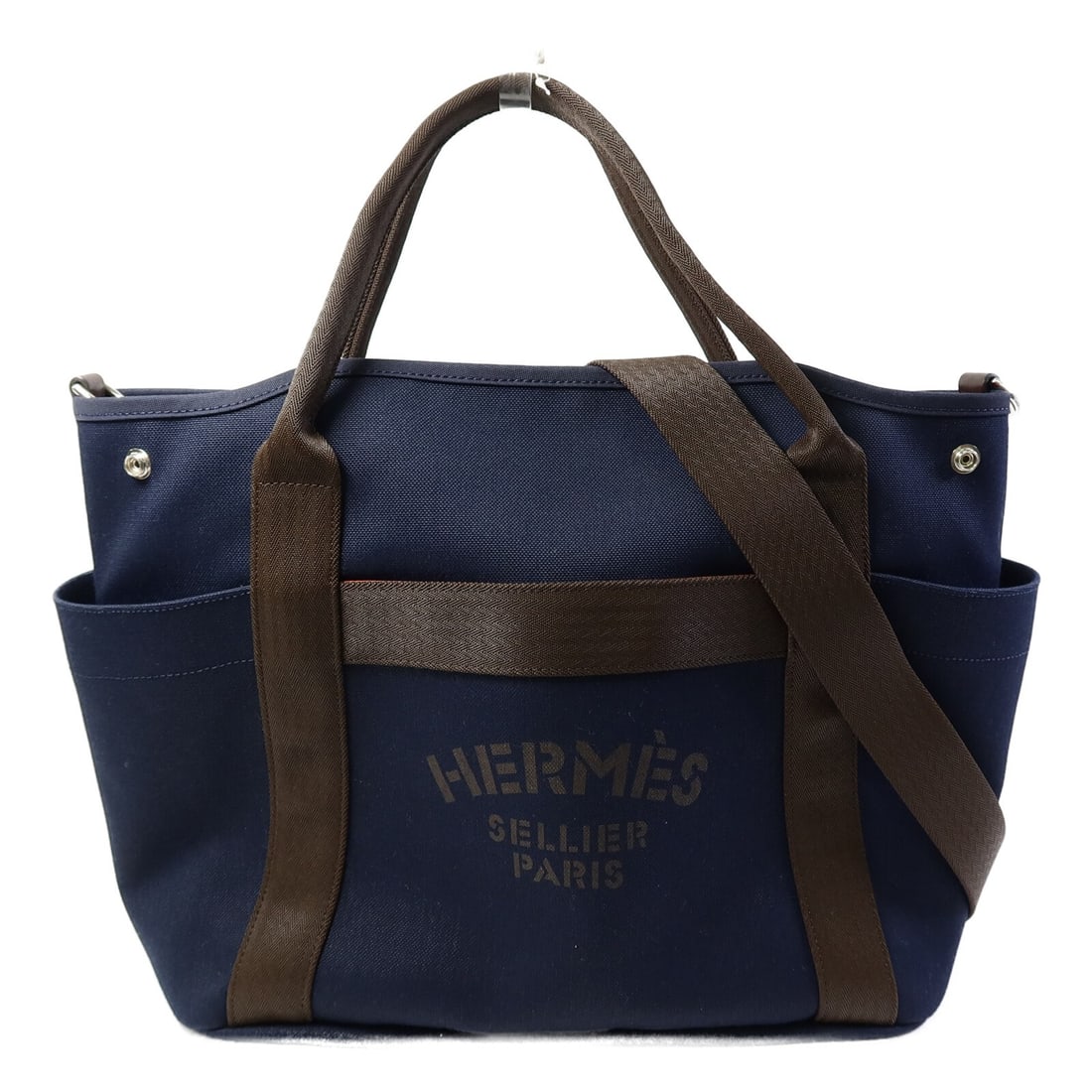 Hermes Grooming Canvas Shoulder Bag with Palladium Hardware in Blue and Brown: Hermes Grooming Canvas Shoulder Bag with Palladium Hardware in Blue and Brown This Hermes 2-way shoulder bag is crafted from durable canvas in a blue exterior color with brown accents. Designed for ve