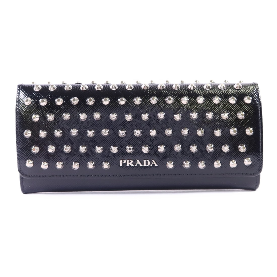 Black Patent Leather Bifold Wallet by Prada with Silver Tone Hardware: Black Patent Leather Bifold Wallet by Prada with Silver Tone Hardware This Prada bifold purse features a sleek black patent leather exterior and a long wallet design. Crafted in Italy, it offers a sop