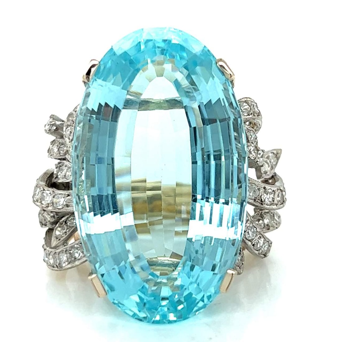 18K Yellow White Gold Aquamarine Ring 62.40 Ct with 74 Diamonds: 18K Yellow White Gold Aquamarine Ring 62.40 Ct with 74 Diamonds This stunning ring features a captivating 62.40 ct. aquamarine at its center, elegantly set in a combination of 18K yellow and white gol