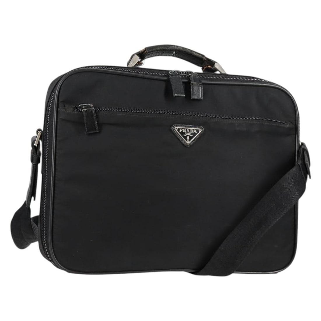 Black Nylon PRADA Two-Way Handbag with Shoulder Strap and Leather Trim: Black Nylon PRADA Two-Way Handbag with Shoulder Strap and Leather Trim This PRADA handbag features a versatile 2-way design crafted from black nylon with silver-tone accents. Made in Italy, it offers 