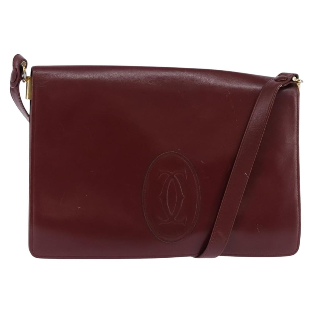 CARTIER Must Line Bordeaux Leather Shoulder Bag with Gold Accents: CARTIER Must Line Bordeaux Leather Shoulder Bag with Gold Accents Introducing the CARTIER Must Line Shoulder Bag, a stylish and functional accessory crafted from luxurious leather in a rich bordeaux a