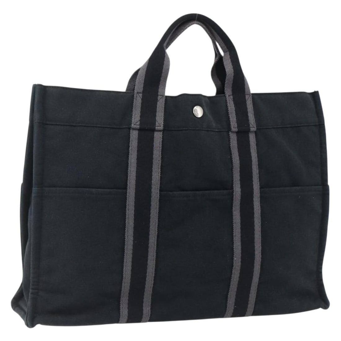 Black Canvas Fourre Tout MM Tote by Hermes Silver Accents: Black Canvas Fourre Tout MM Tote by Hermes Silver Accents This HERMES Fourre Tout MM hand bag is crafted from black canvas with silver-tone details. Designed for women, it features a spacious interior