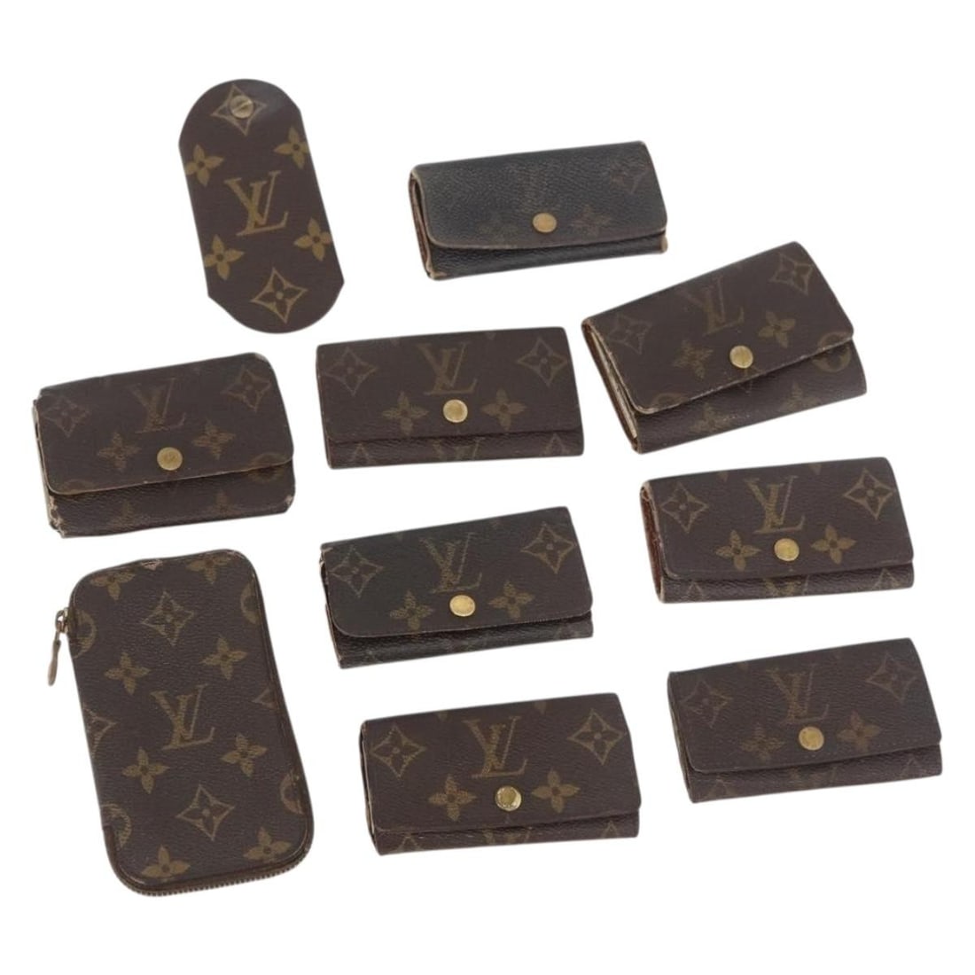 Louis Vuitton Monogram Canvas Key Case 10 Piece Set: Louis Vuitton Monogram Canvas Key Case 10 Piece Set This Louis Vuitton Monogram Key Case is crafted from monogram canvas and is designed for women. The item exhibits significant signs of use, includin
