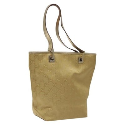Gucci Gold GG Canvas Tote Bag 002 1099 Italy: Gucci Gold GG Canvas Tote Bag 002 1099 Italy This Gucci GG Canvas tote bag features a gold colorway and classic GG canvas material. The bag is designed with a spacious interior and sturdy handles, mak