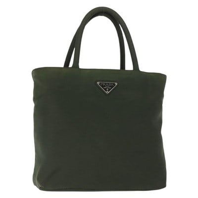 PRADA Khaki Silver Nylon Handbag Italy: PRADA Khaki Silver Nylon Handbag Italy This PRADA hand bag is crafted from khaki nylon with silver-tone hardware. Made in Italy, it features a practical design with a top handle and a compact silhouet