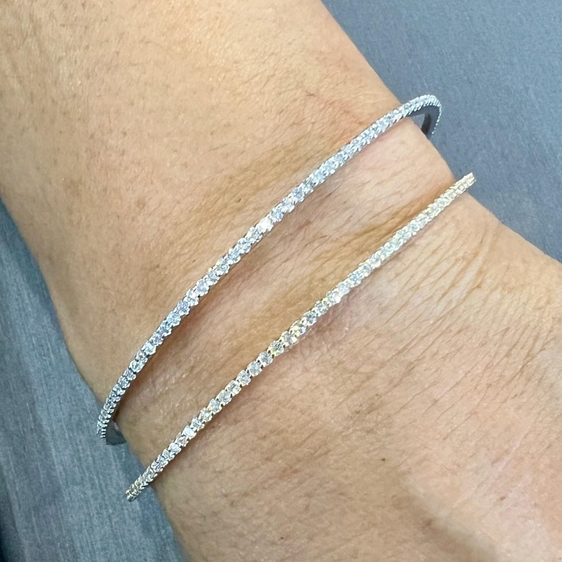Elegant 18K Yellow and White Gold Diamond Bangles Pair 5.00 Ct: Elegant 18K Yellow and White Gold Diamond Bangles Pair 5.00 Ct This exquisite pair of diamond bangles is crafted from 18K yellow and white gold, offering a stunning contrast that enhances the brillian