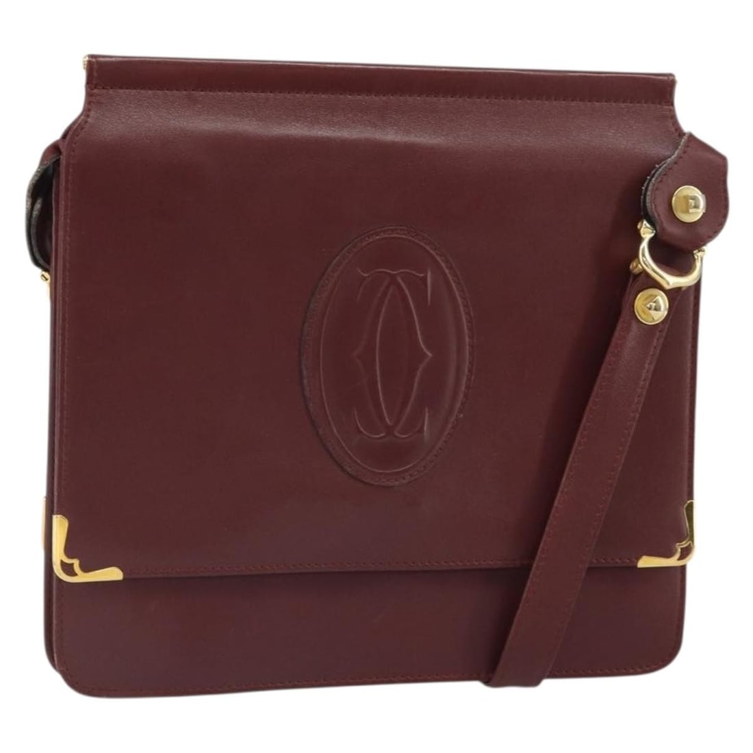 Must Line Bordeaux Leather Shoulder Bag by Cartier with Guarantee Card: Must Line Bordeaux Leather Shoulder Bag by Cartier with Guarantee Card This Cartier Must Line shoulder bag features a bordeaux leather exterior with gold-tone accents. The bag includes an adjustable s