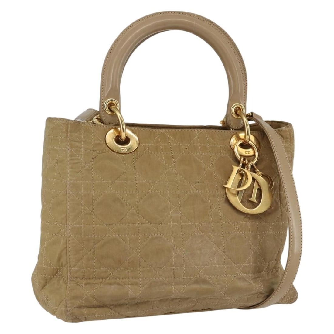 Christian Dior Lady Dior nylon beige gold handbag with strap and charm: Christian Dior Lady Dior nylon beige gold handbag with strap and charm This Christian Dior Lady Dior Canage handbag is crafted from beige and gold nylon, offering a versatile 2-way carry option as bot