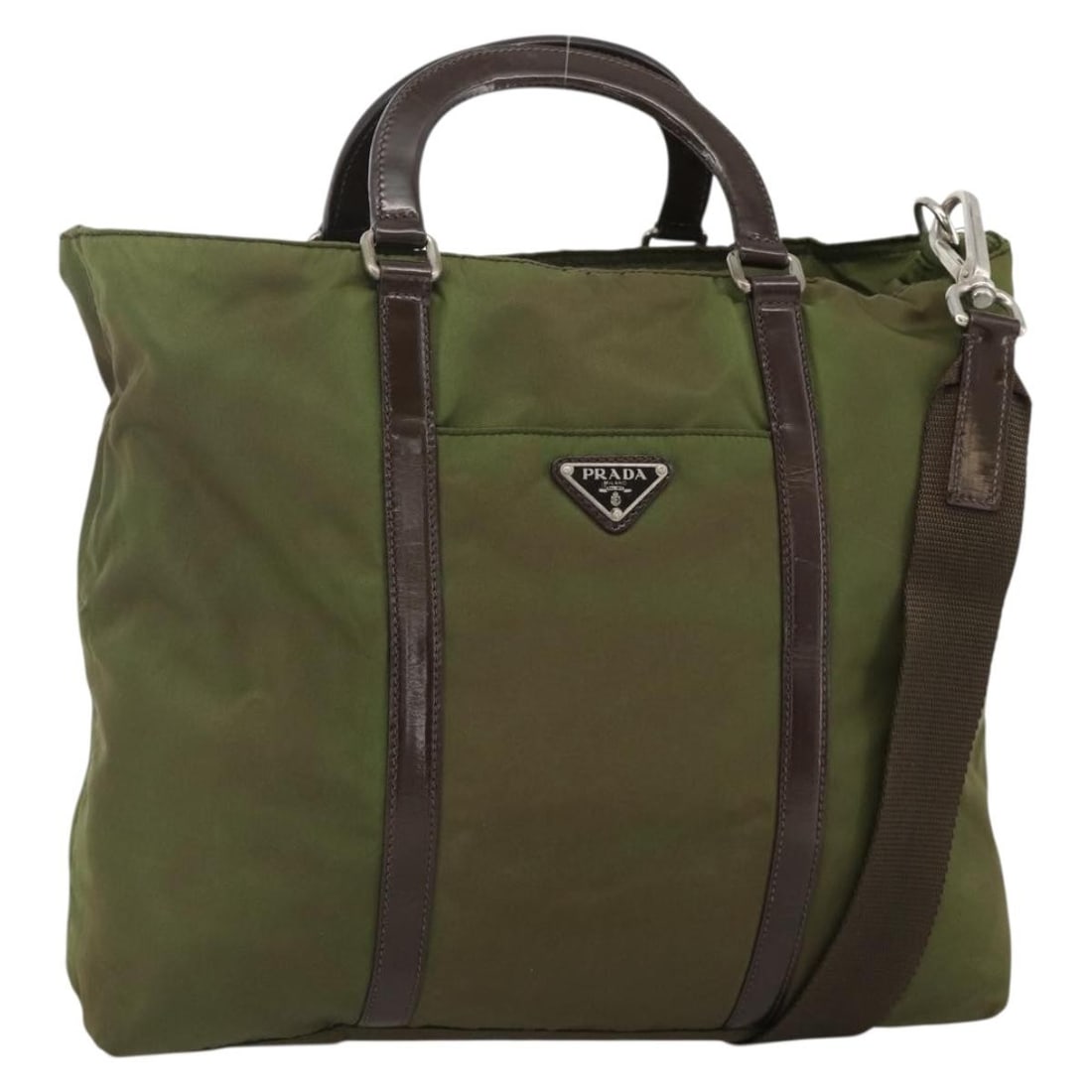 Prada khaki nylon handbag with shoulder strap Italy: Prada khaki nylon handbag with shoulder strap Italy This PRADA handbag offers versatile 2-way carrying options and is crafted from durable khaki nylon with silver-tone accents. Designed for women, it 