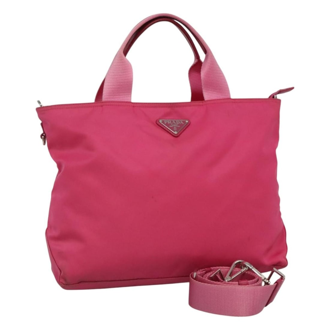 Pink Nylon 2way Shoulder and Handbag by Prada with Silver Accents: Pink Nylon 2way Shoulder and Handbag by Prada with Silver Accents This PRADA 2-way handbag features a pink and silver nylon exterior and offers both handheld and shoulder-carry options. Designed for w