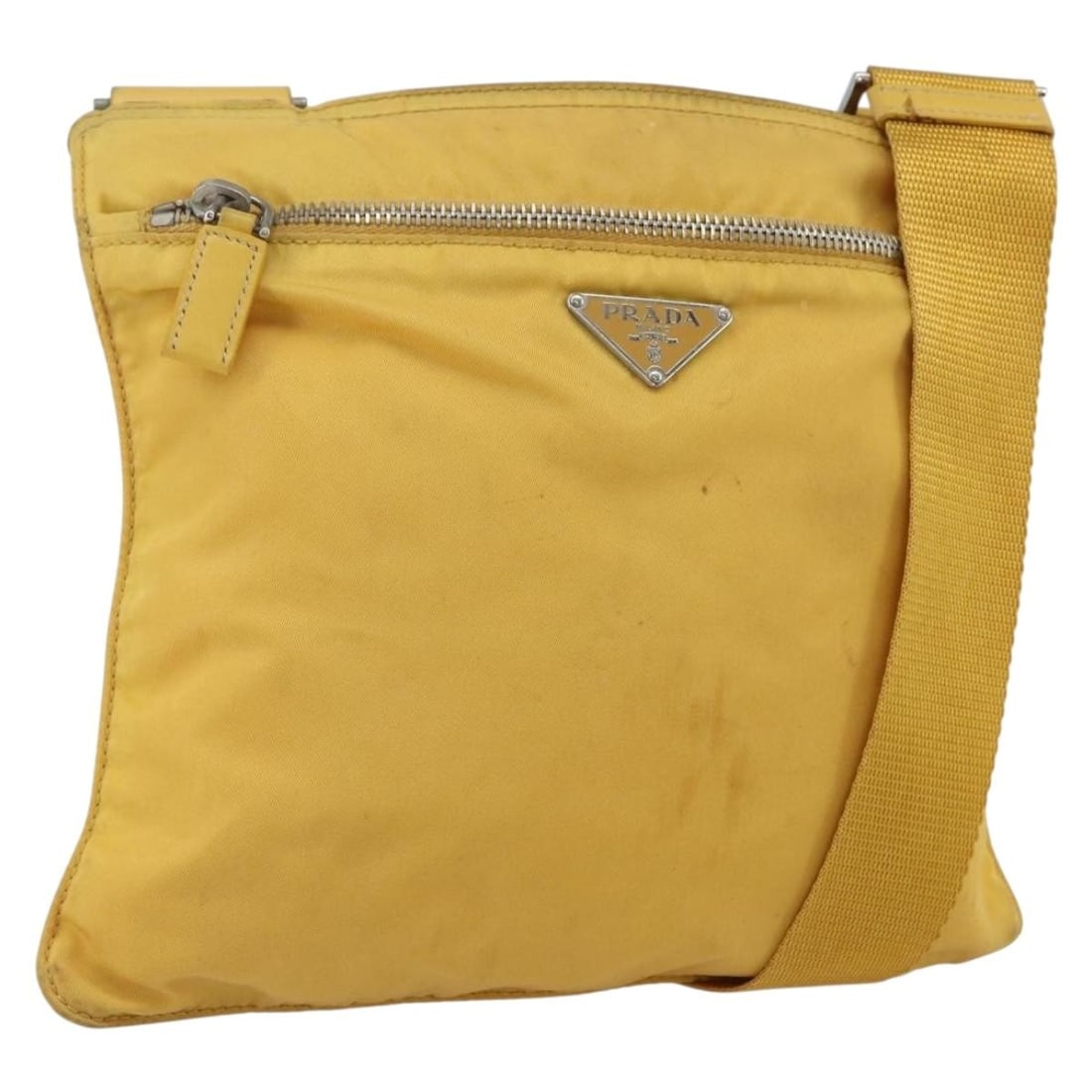 Prada yellow nylon shoulder bag silver trim Italy: Prada yellow nylon shoulder bag silver trim Italy This PRADA shoulder bag is crafted from yellow and silver nylon and features an adjustable shoulder strap. The bag shows significant signs of use, inc