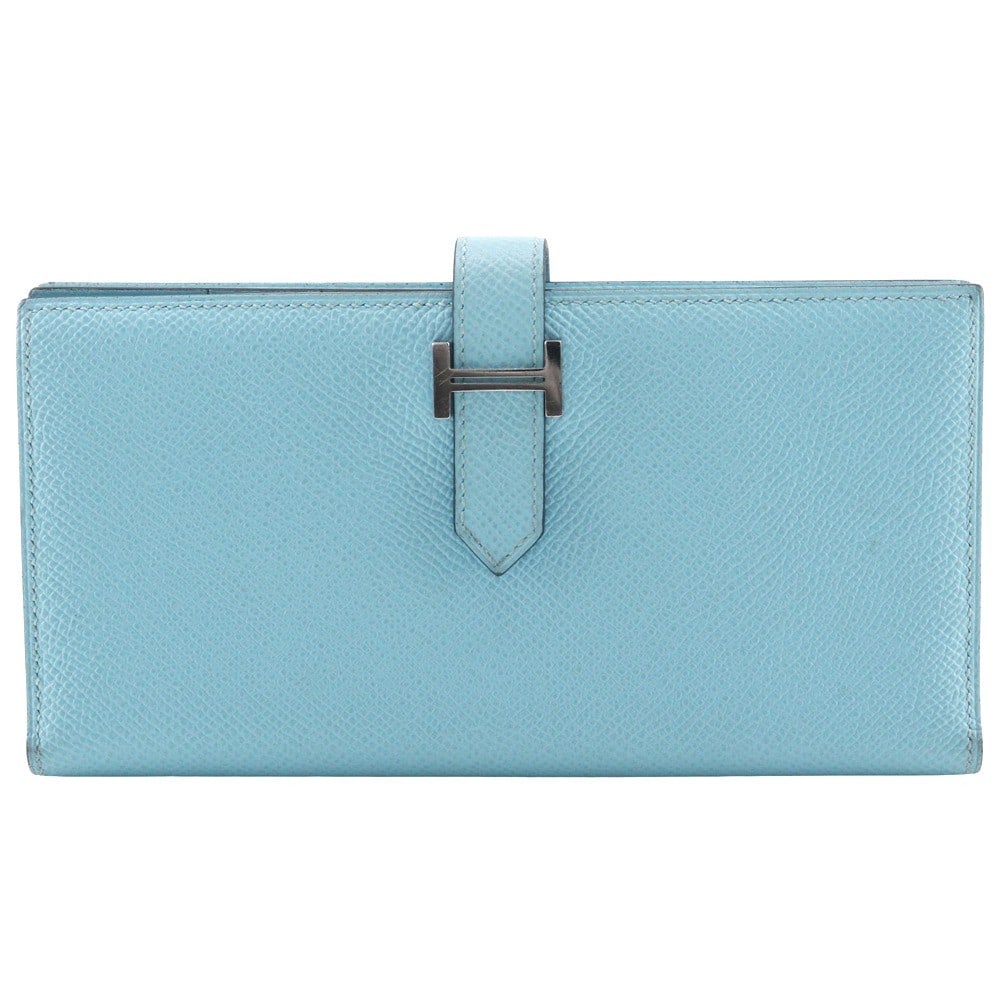 Blue Epsom Leather Bearn Long Wallet by Hermes France: Blue Epsom Leather Bearn Long Wallet by Hermes France This Hermes Bearn Wallet is crafted from blue leather and designed for women. It features a sleek silhouette with minor stains, scratches, and cor