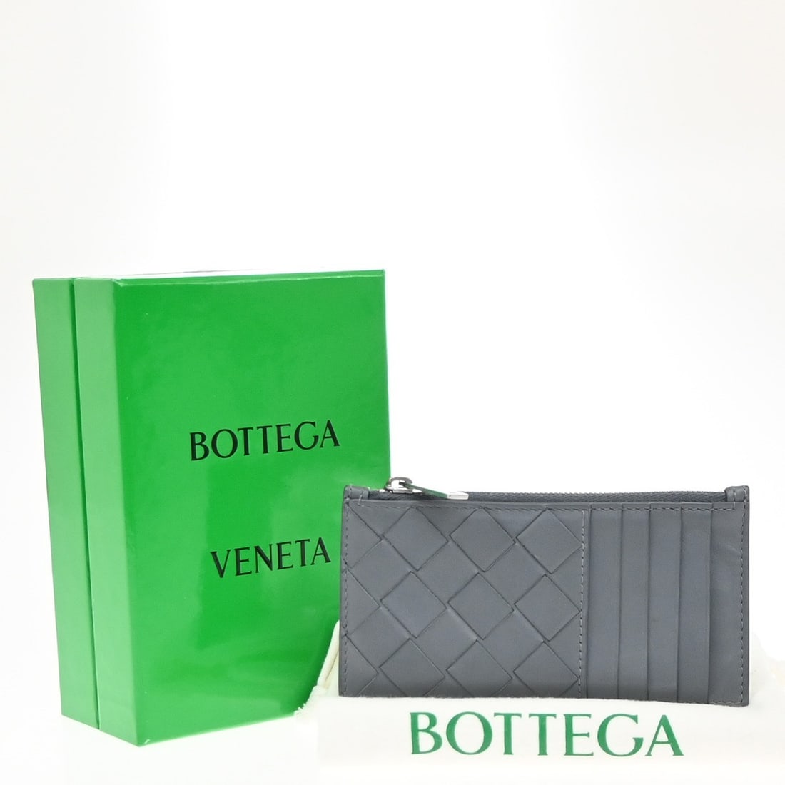 Gray Leather Card Holder by Bottega Veneta with Zipper: Gray Leather Card Holder by Bottega Veneta with Zipper This unisex zipped card holder by Bottega Veneta features signature Intrecciato leather in gray. Crafted in Italy, the compact design measures 13
